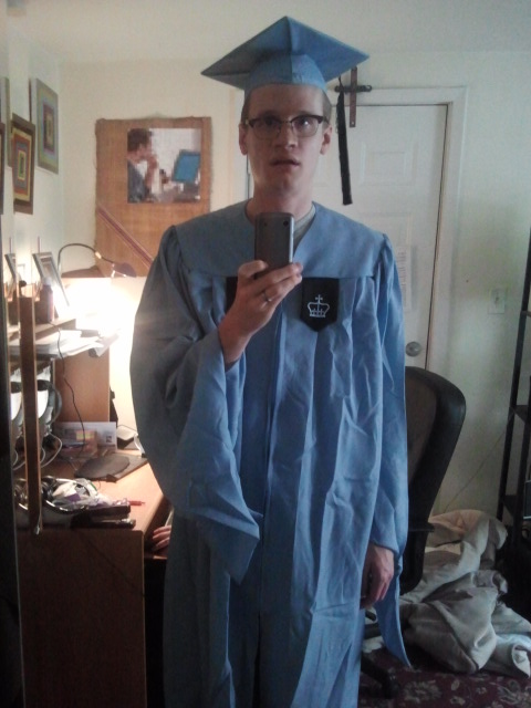 Mirror selfie of Jeremy wearing his baby blue university graduate outfit.