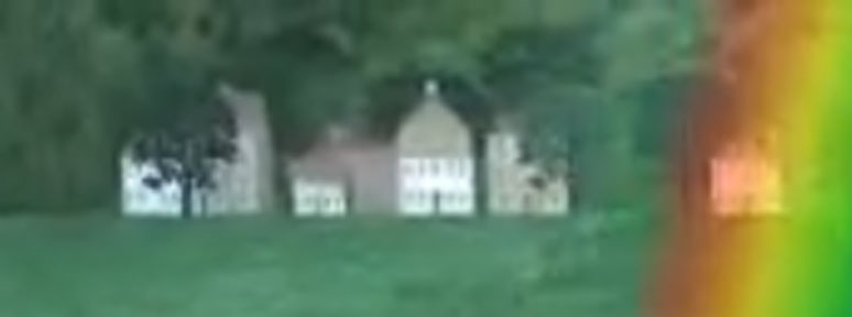 A zoomed in crop of the small town from the previous image, it is blurry and hard to determine.